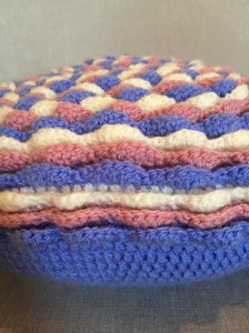Side view of crochet blooming flower cushion
