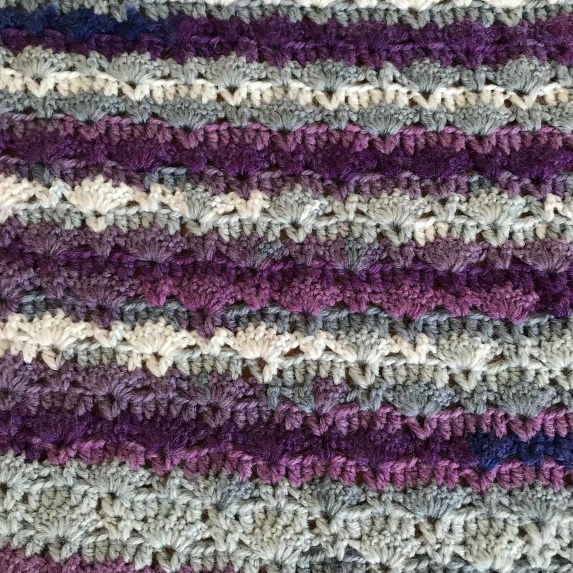 Close up of sunrise shawl using hayfield spirit yarn